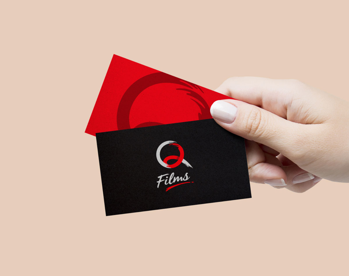 hand holding film production company business cards
