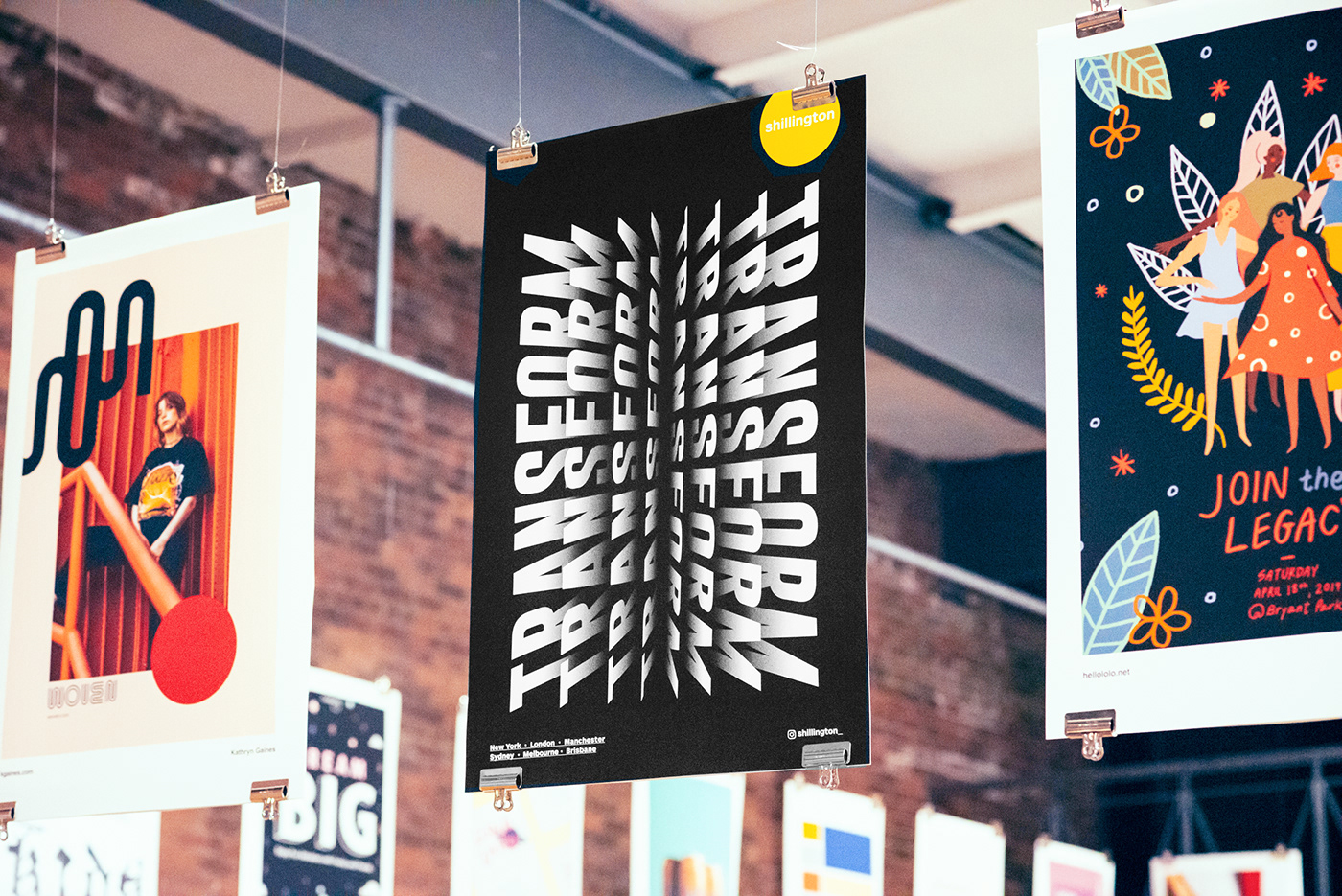 Poster Design hanging from roof of gallery