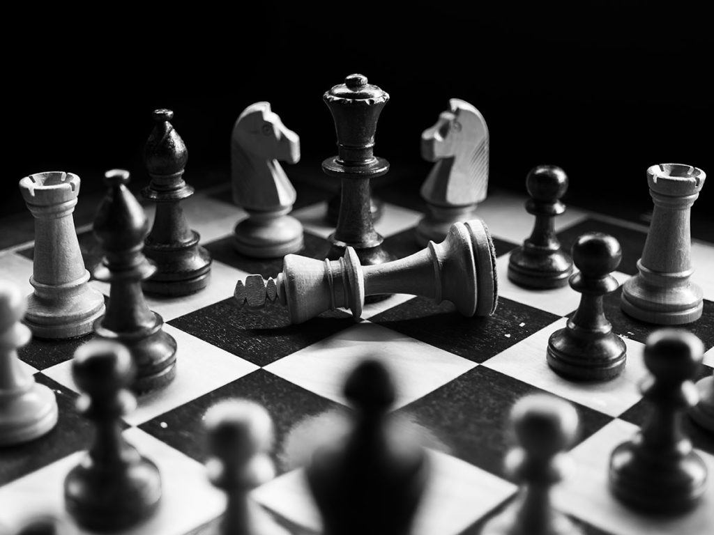 photo of chess board with the king lying on its side