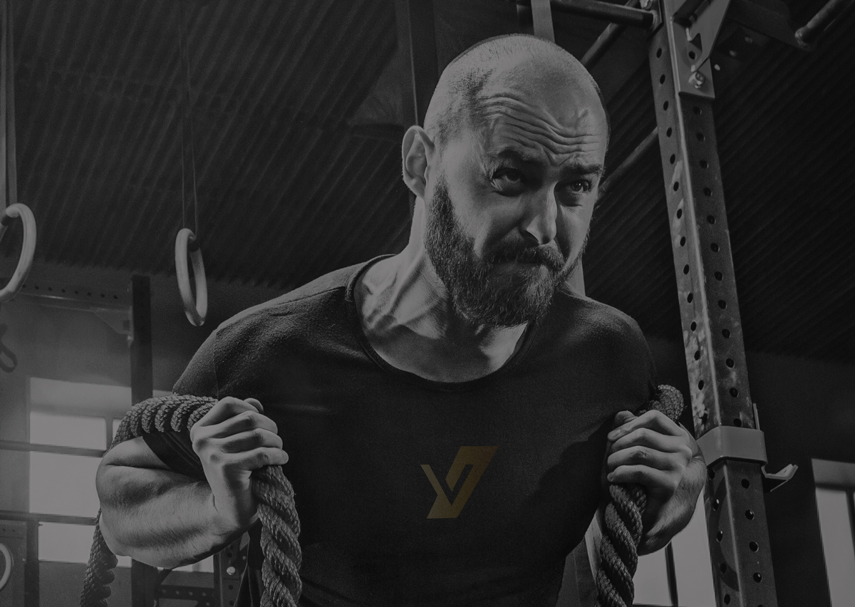 man working out in a gym with ropes