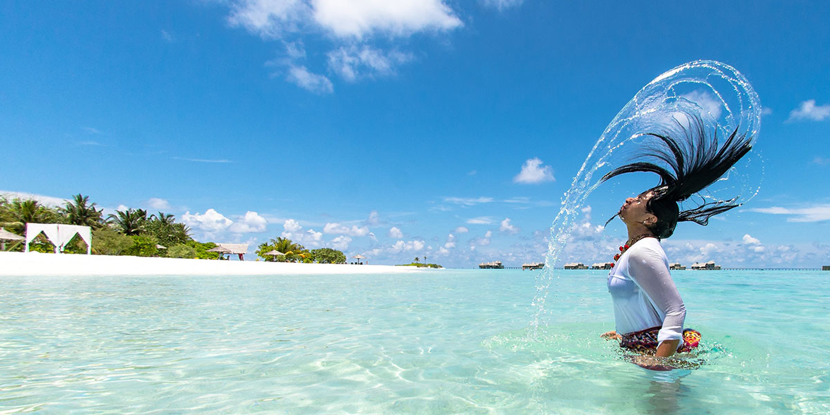 photo of a woman in the water flipping her hair