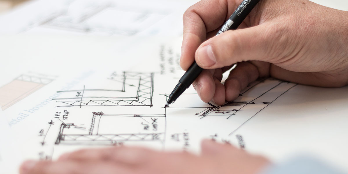The AARRR Model shown by a hand sketching plans on paper