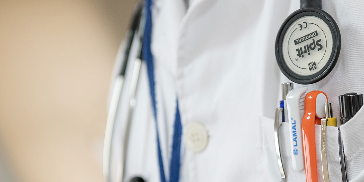 medical logo on a pen clipped to a medical apron