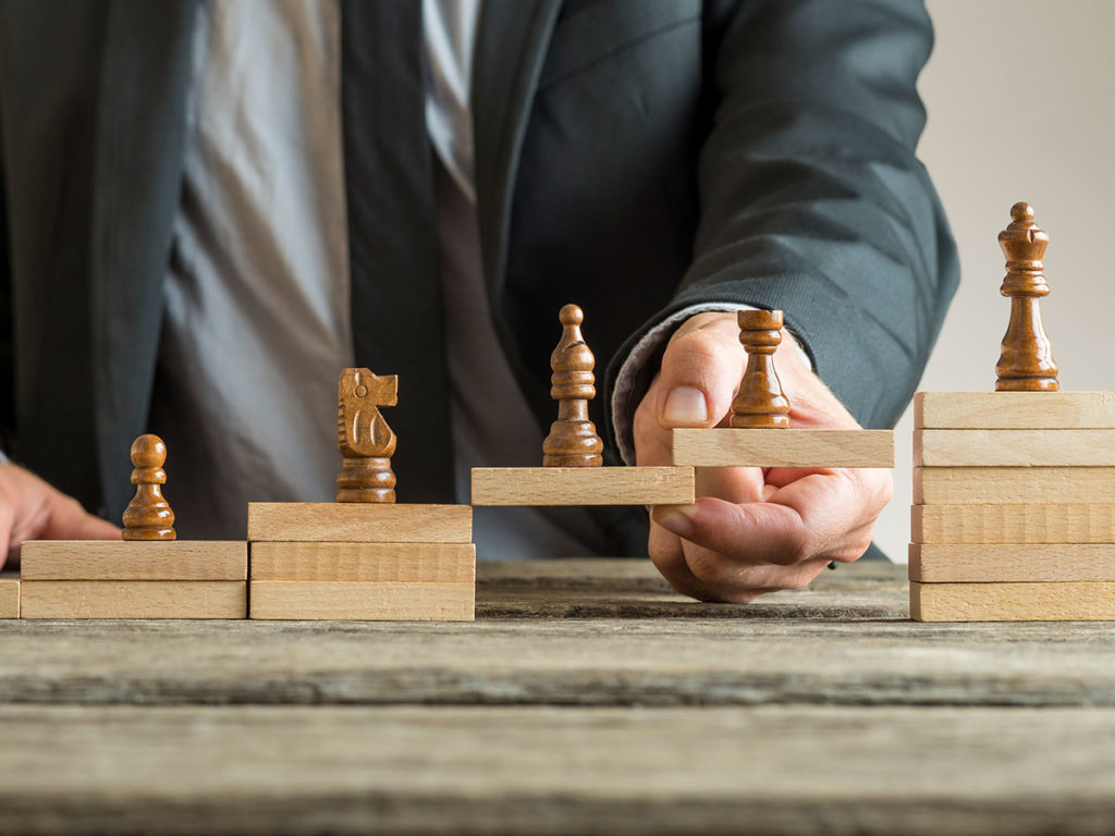 Brand Perception concept being shown with chess pieces being stacked on wooden block